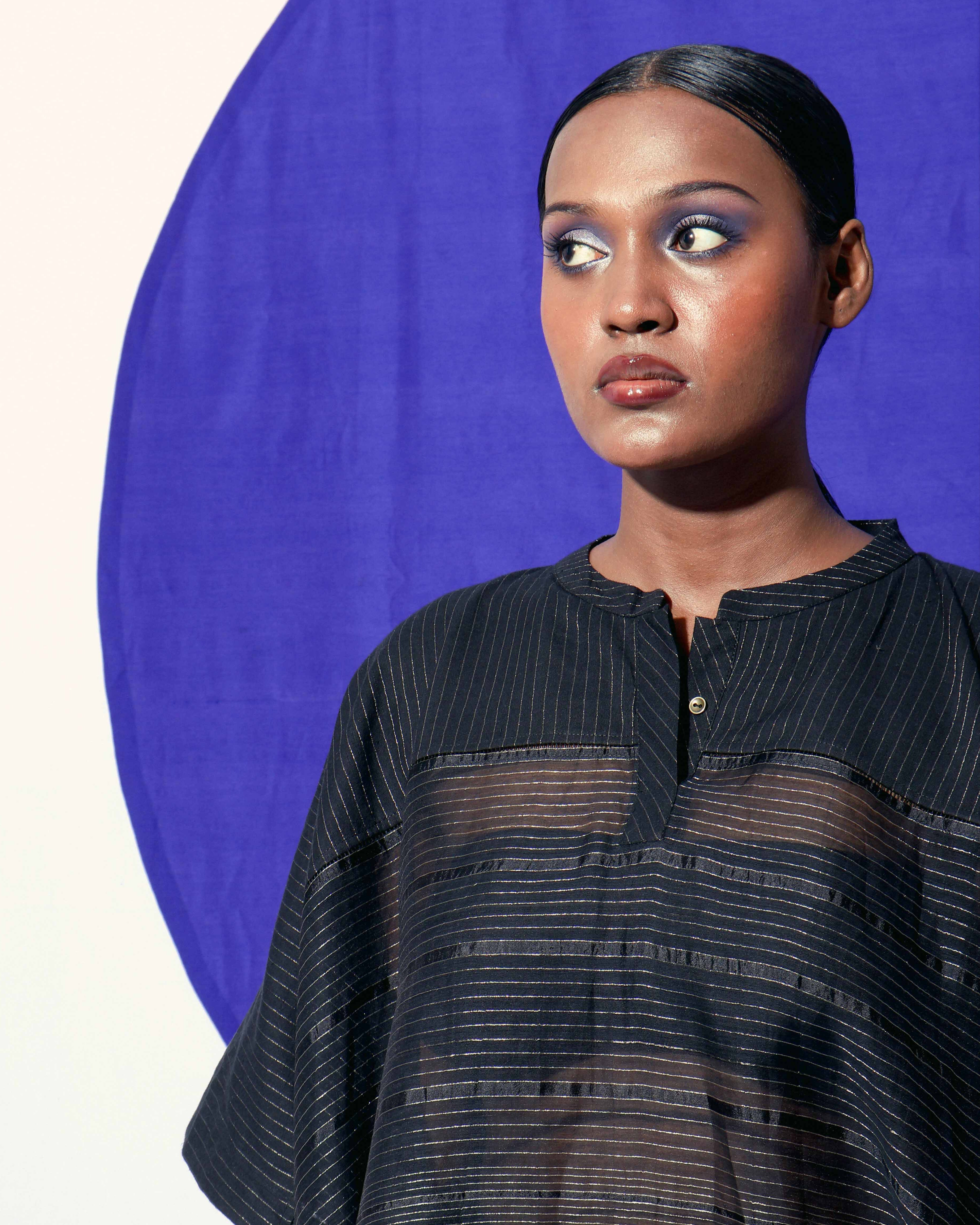 The Shoonyata Gradient Stripe Mandarin Top is crafted from handwoven silk using the traditional technique. It features a relaxed, boxy silhouette that drapes beautifully on the body