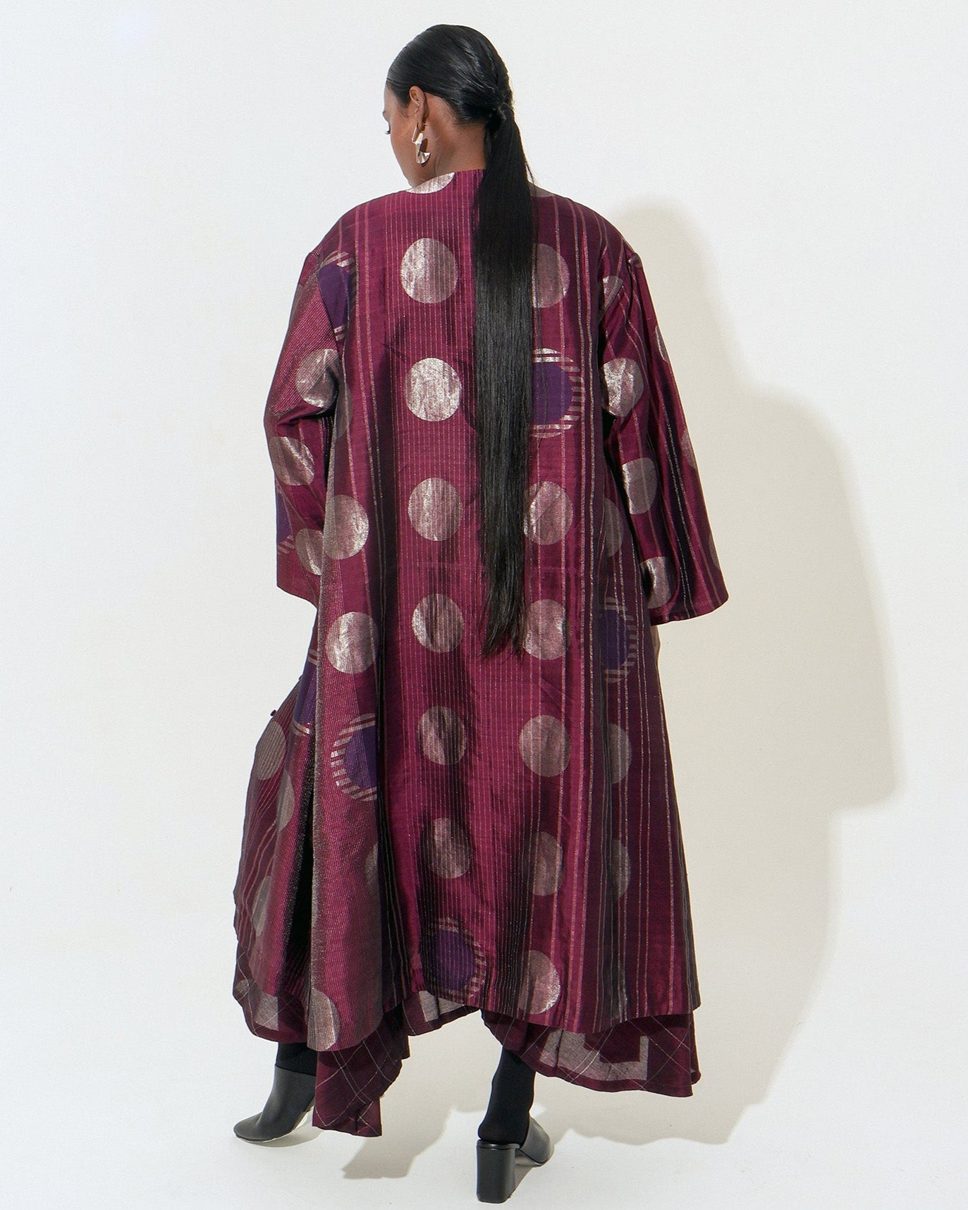 The Shoonyata Multiple Circle Jacket Dress is crafted from handwoven silk using the traditional Jacquard Jamdani technique, The jacket features an open-front design with three-quarter-length sleeves.