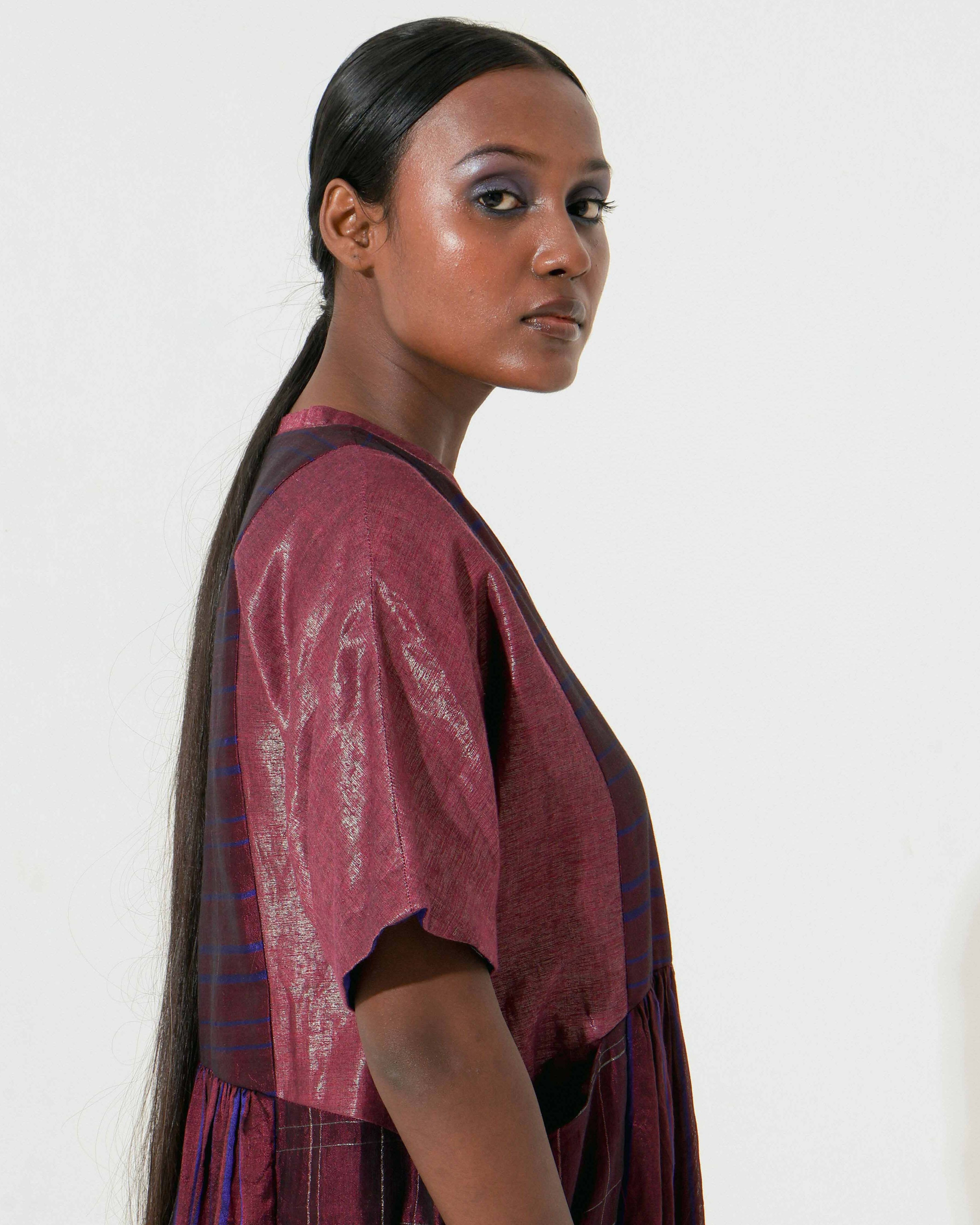 The Shoonyata Panelled Gathered Dress is handwoven from silk using the traditional Bengal weaving technique . It features a relaxed A-line silhouette.