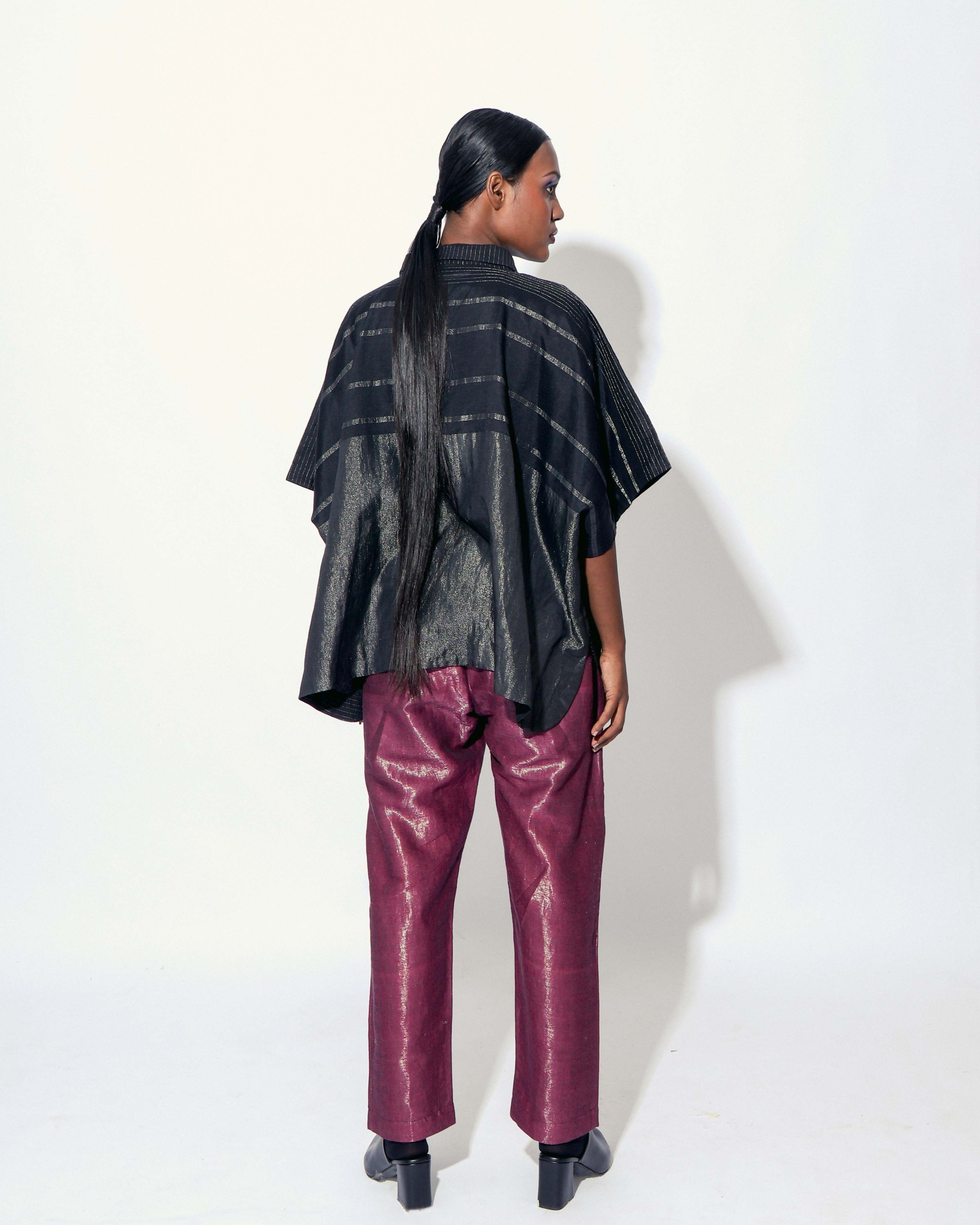 The Shoonyata Striped Circle Hi-Low Top features a relaxed silhouette with a structured yet flowing fit. The Top fabric’s is a handwoven silk, crafted using the Jacquard Jamdani weaving technique.