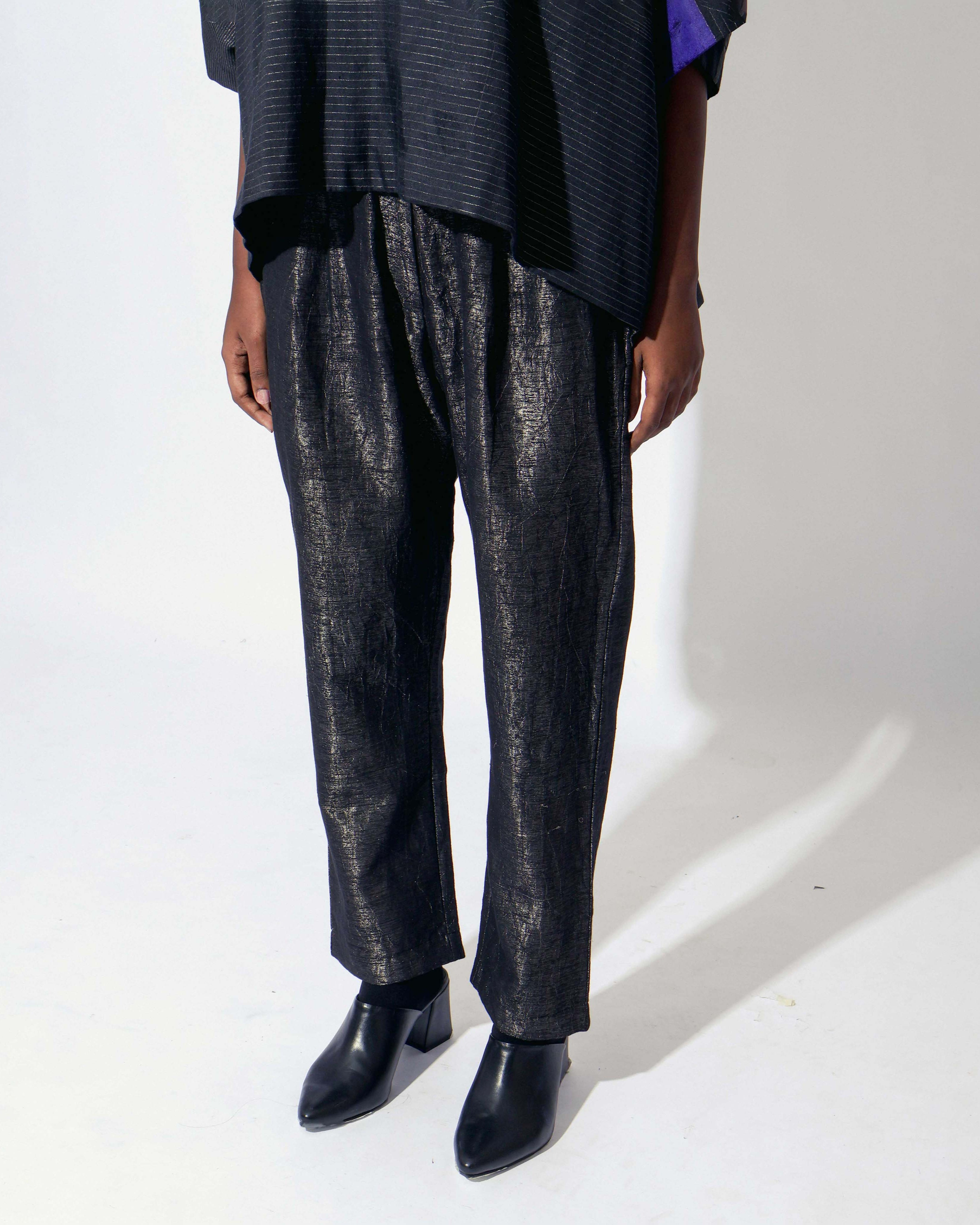 The Shoonyata Burnished Tissue Pants are crafted from silk tissue fabric with a subtle burnished finish, creating a soft shimmer. These relaxed-fit pants feature a gently tapered silhouette that combines comfort with contemporary style.
