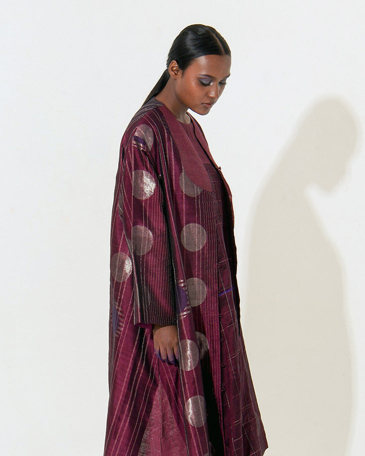 The Shoonyata Multiple Circle Jacket Dress is crafted from handwoven silk using the traditional Jacquard  Jamdani technique, The jacket features an open-front design with three-quarter-length sleeves.