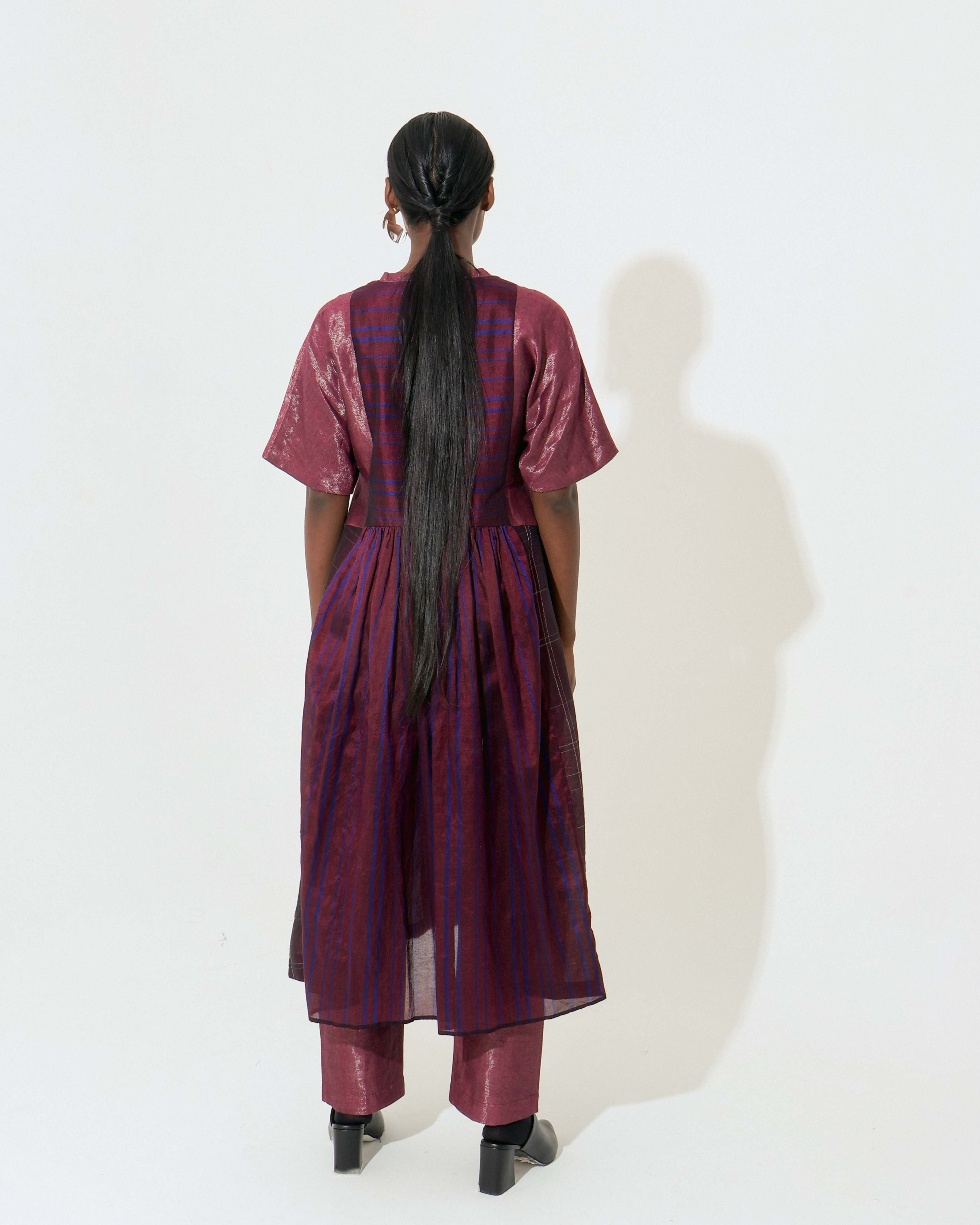 The Shoonyata Panelled Gathered Dress is handwoven from silk using the traditional Bengal weaving technique . It features a relaxed A-line silhouette.