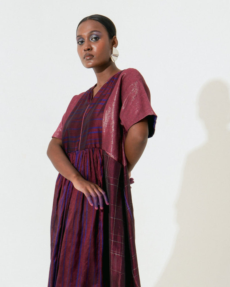 The Shoonyata Panelled Gathered Dress is handwoven from silk using the traditional Bengal weaving technique . It features a relaxed A-line silhouette.
